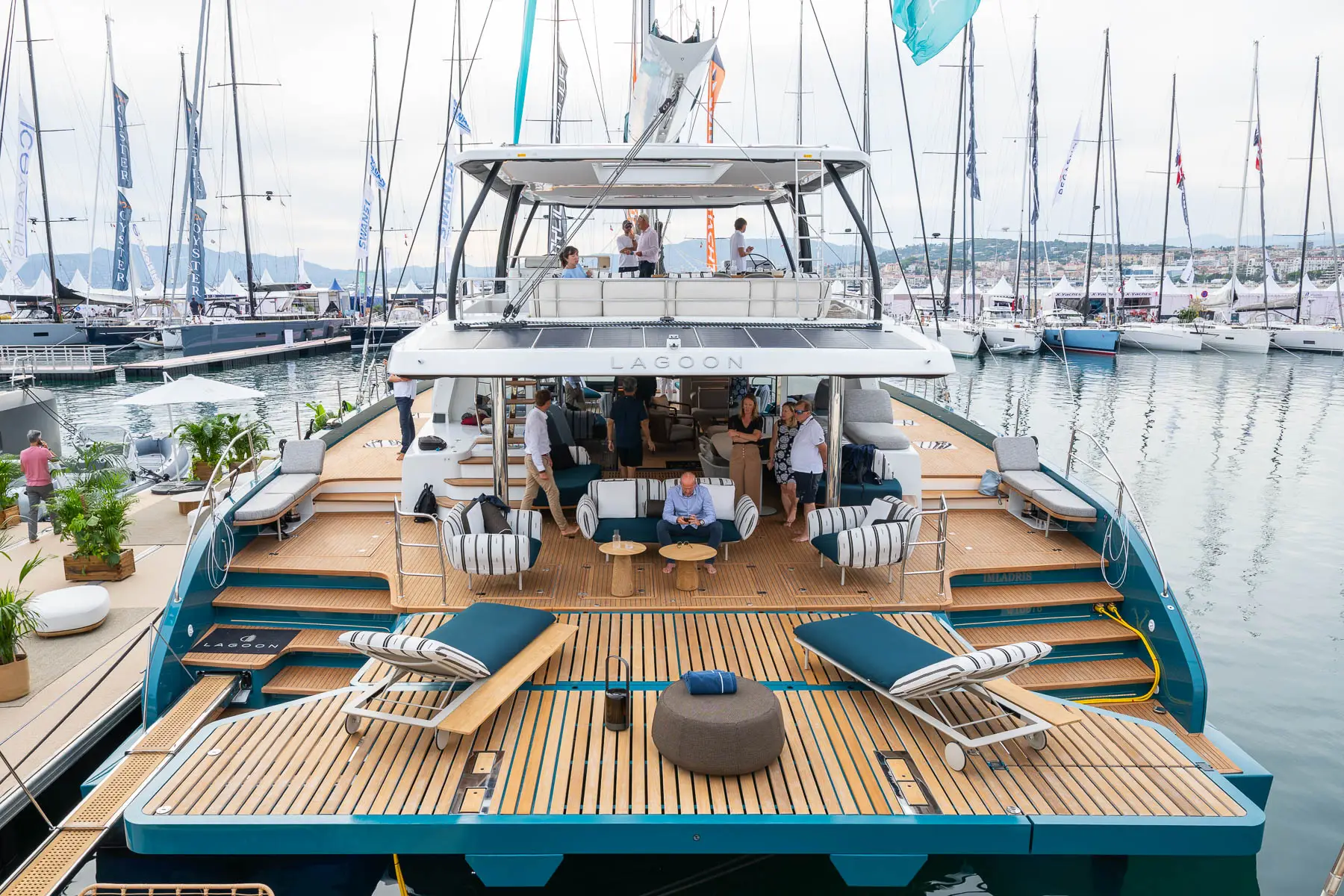Aft deck of a large catamaran with sun loungers at a boat show