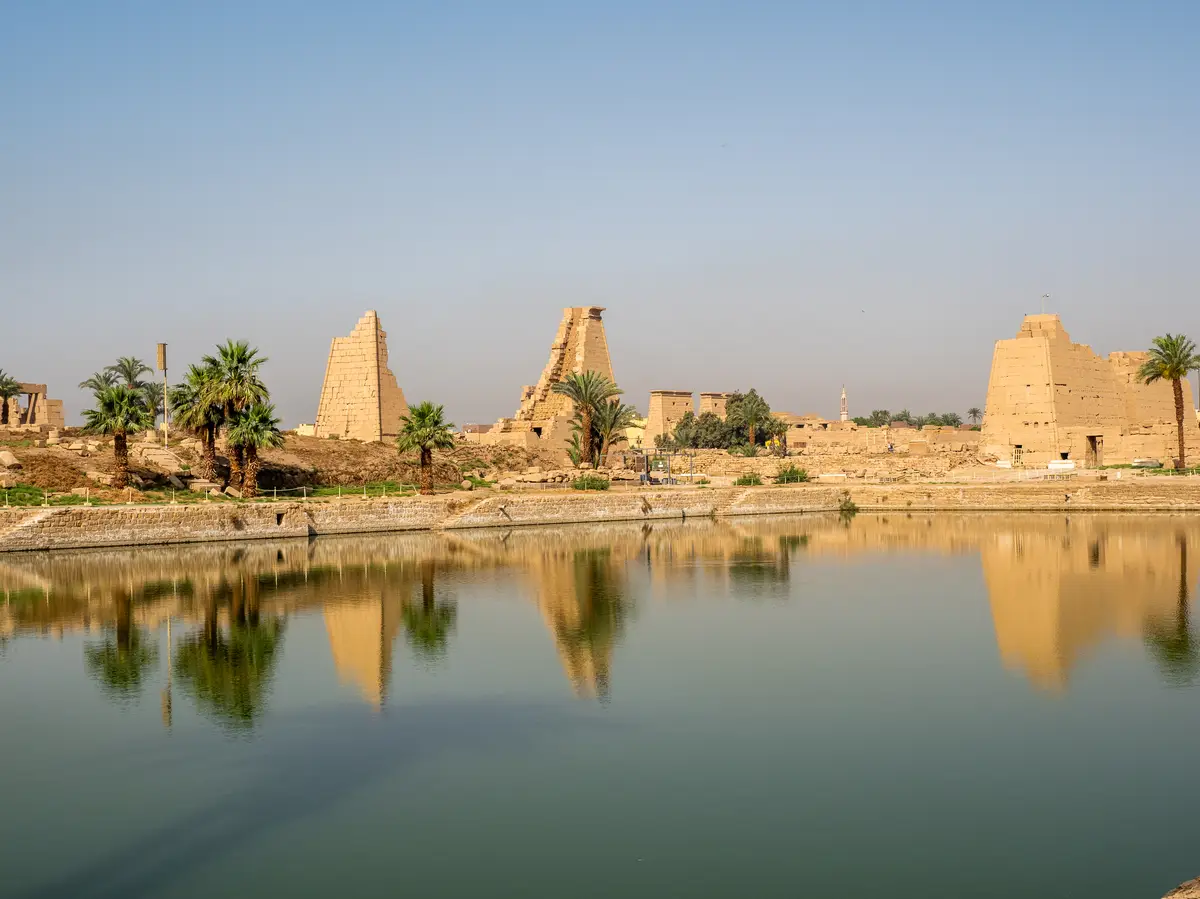 Karnak Temple and palm trees reflected in the sacred lake, Luxor